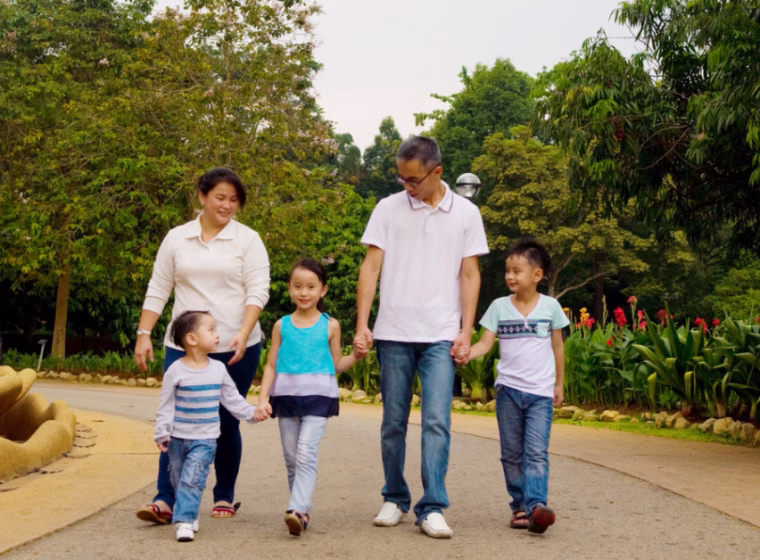 asian family is walking in a garden